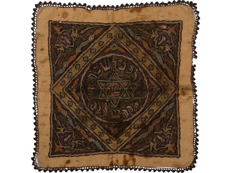 Embroidered Sabbath tablecloth. [Ottoman Empire, early 20th century].
 Linen, embroidery and metal threads.
 Square tableclot