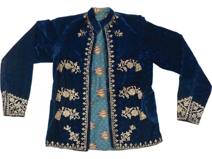 Short ceremonial coat. [Iraq-Persia, early 20th century].
 Velvet, golden threads embroidery.
 Dark blue velvet coat decorate