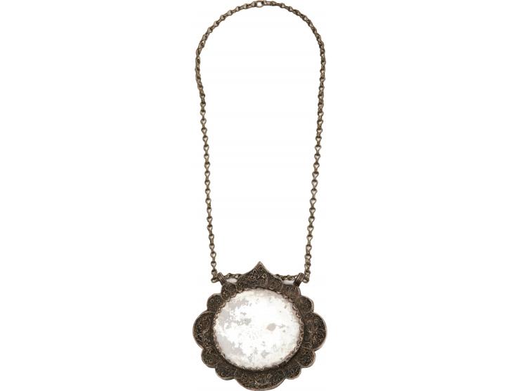 Two necklaces and a pendant. [Central Asia, early 20th century].
 1. Necklace with a large silver pendant with two loops and 
