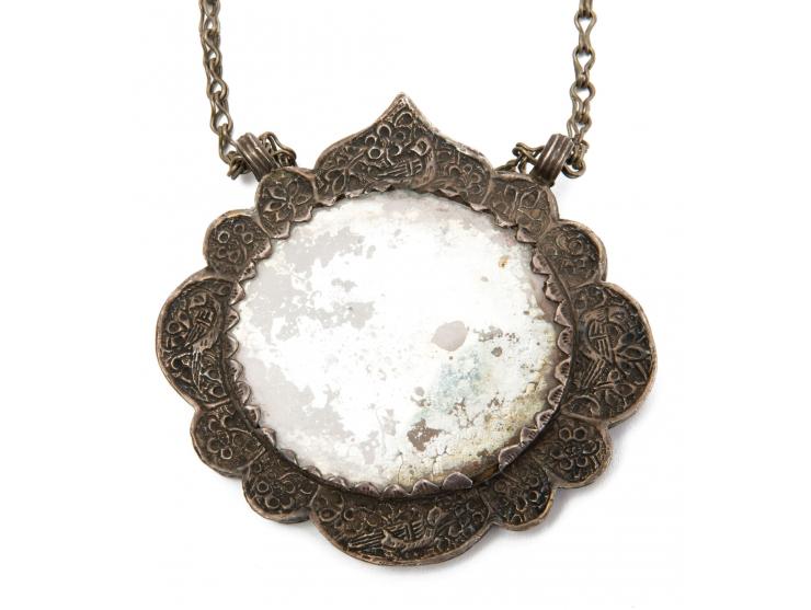 Two necklaces and a pendant. [Central Asia, early 20th century].
 1. Necklace with a large silver pendant with two loops and 