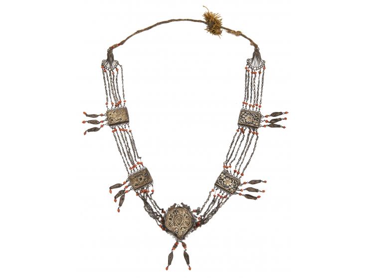 Two necklaces and a pendant. [Central Asia, early 20th century].
 1. Necklace with a large silver pendant with two loops and 